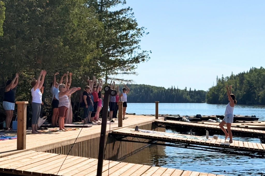 Women on dock doing somatic breathwork