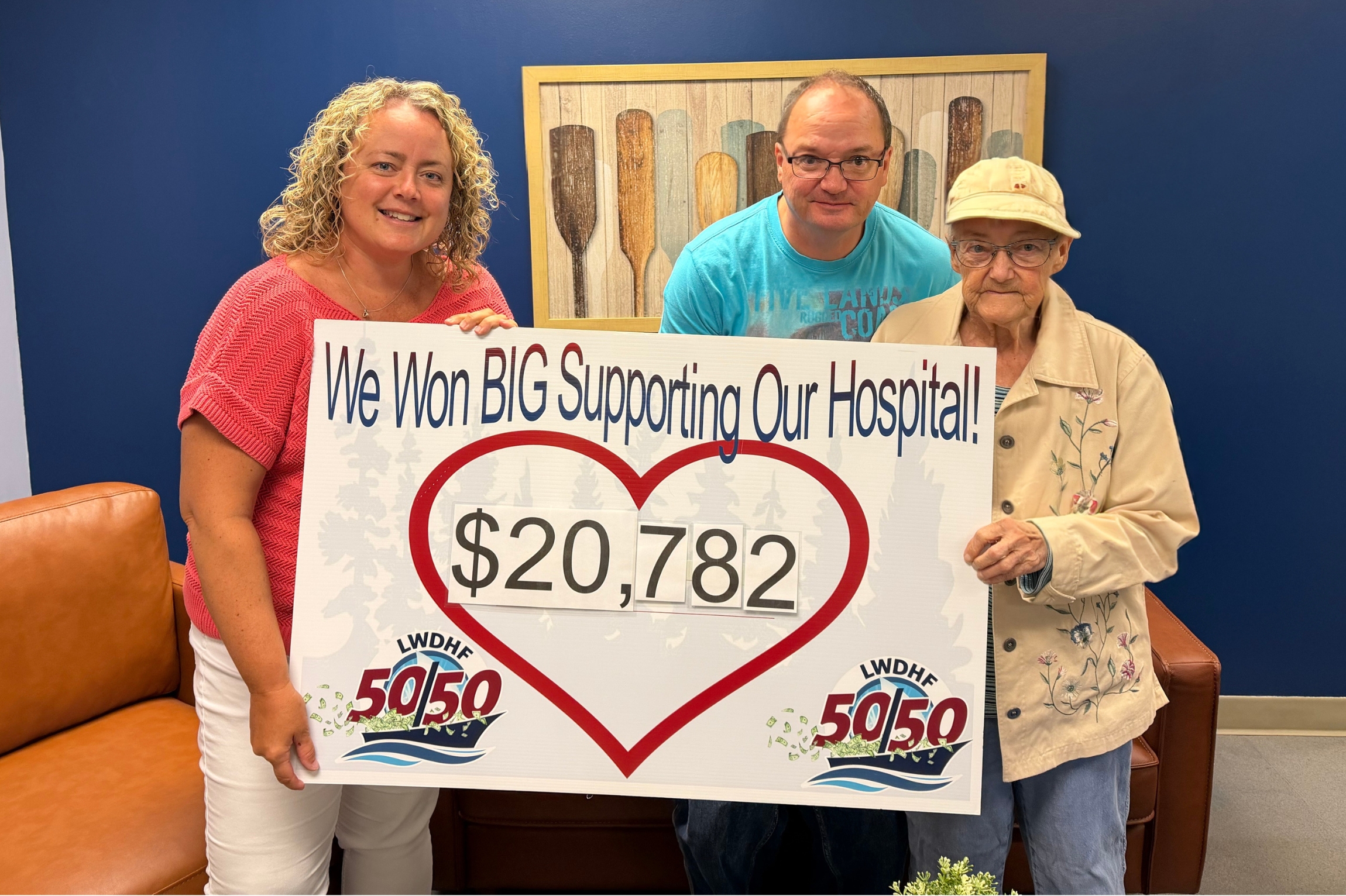 Marilyn Blanchette accepts her jackpot win in the July 50/50 in the amount of $20,782.50